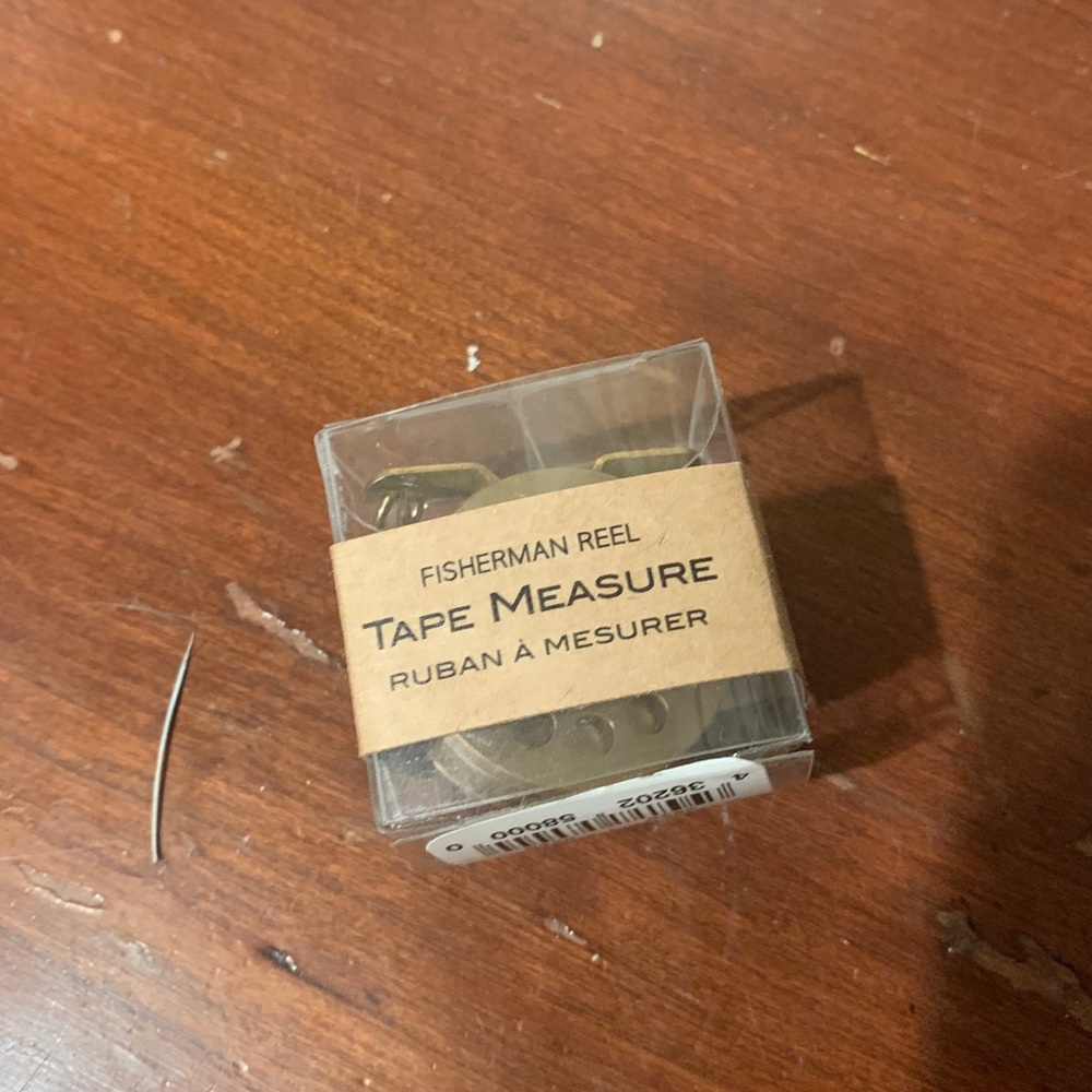 Key chain fishing reel with measuring tape